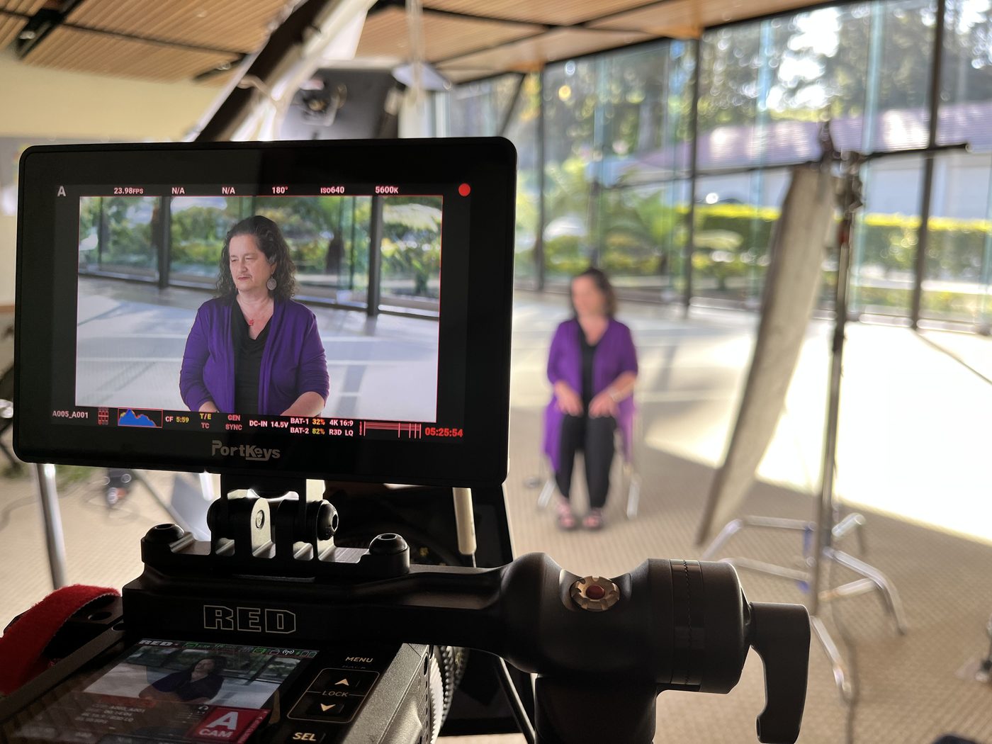 RED camera monitor framing an interview subject on set